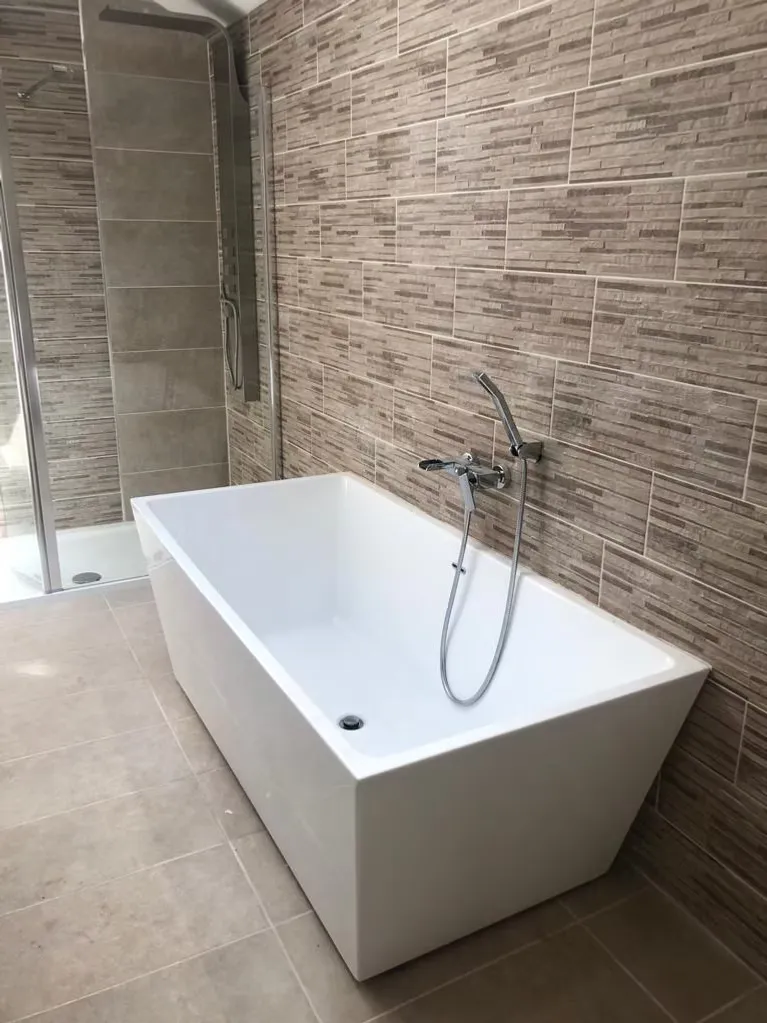 Elegant bathroom with a freestanding bath by Durham Trade Bathrooms
