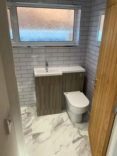 En-suite shower room with vanity and mirrored cabinet