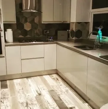 L-shaped kitchen with white and grey cabinetry