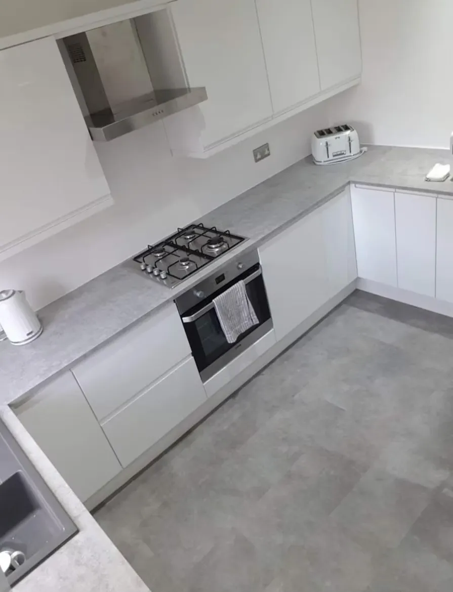 White fitted kitchen with integrated extractor